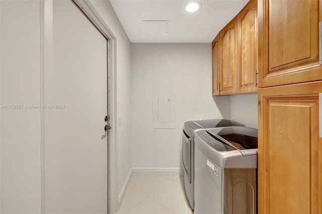 laundry area with cabinets, light tile patterned floors, electric panel, and washer and clothes dryer