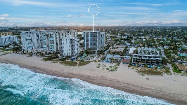 aerial view featuring a view of the beach and a water view