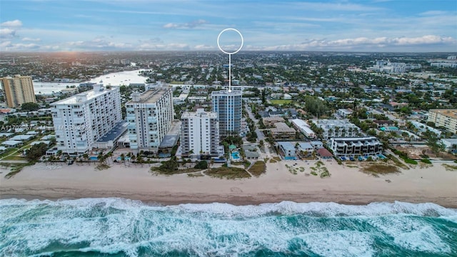 birds eye view of property with a beach view and a water view