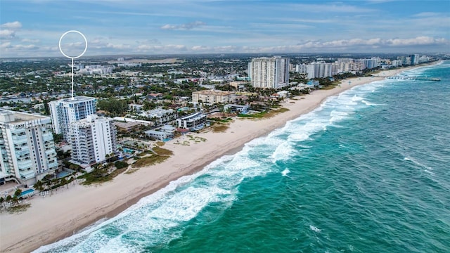 drone / aerial view with a water view and a view of the beach