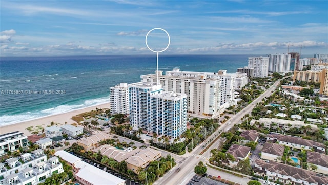 aerial view with a water view and a beach view