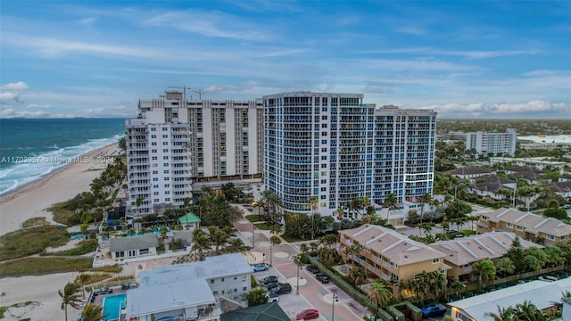 birds eye view of property with a view of the beach and a water view