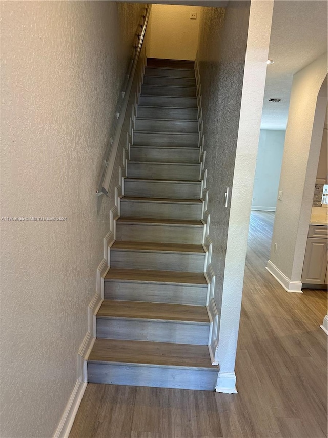 staircase featuring hardwood / wood-style flooring