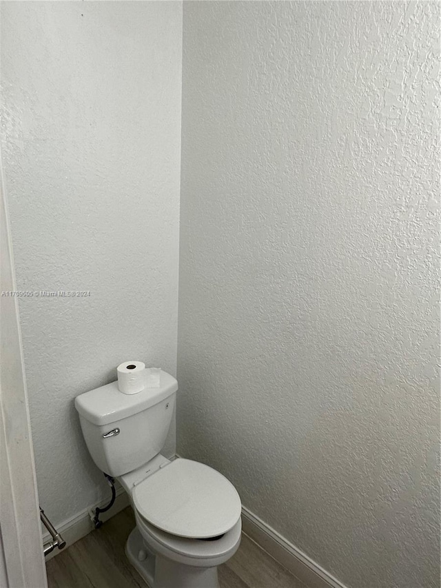 bathroom featuring hardwood / wood-style floors and toilet