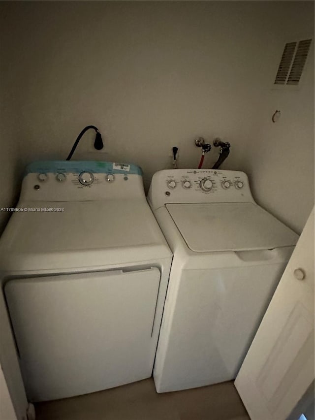 laundry area with washing machine and dryer