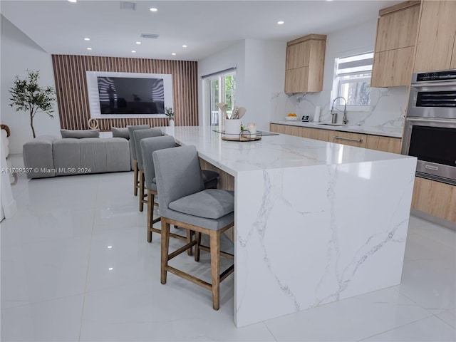 kitchen with a center island, a healthy amount of sunlight, and double oven