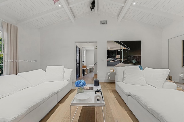 living room featuring vaulted ceiling with beams, light hardwood / wood-style flooring, and wooden ceiling