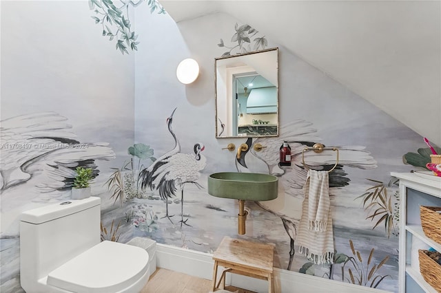 bathroom featuring hardwood / wood-style floors, toilet, and vaulted ceiling