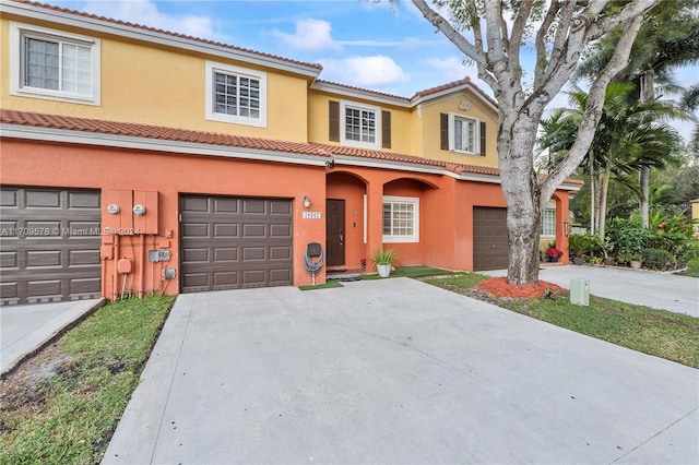 mediterranean / spanish house with a garage