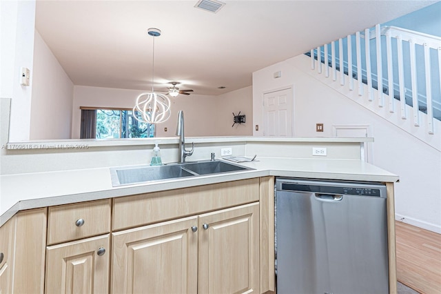 kitchen with a sink, light brown cabinets, light countertops, and stainless steel dishwasher