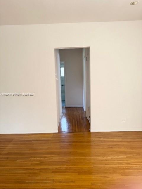 unfurnished room with wood-type flooring