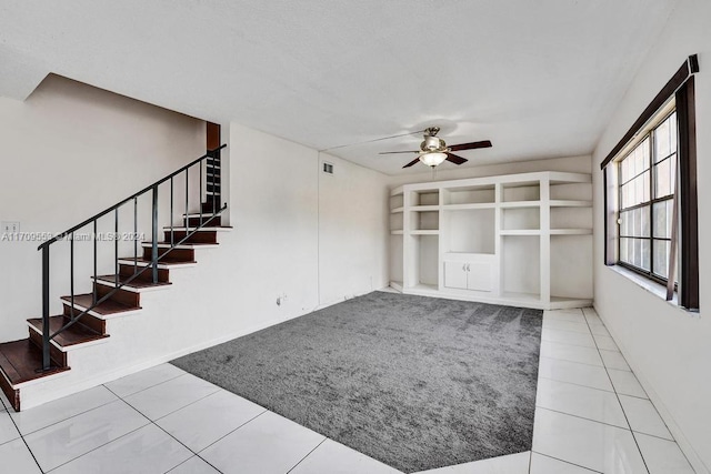 unfurnished living room with tile patterned floors and ceiling fan