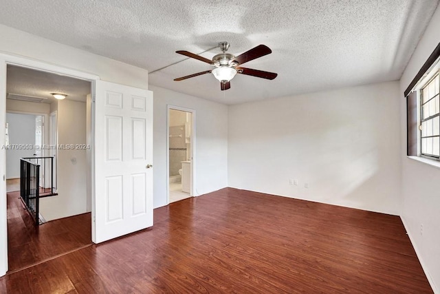 interior space with ceiling fan, dark hardwood / wood-style flooring, and a textured ceiling