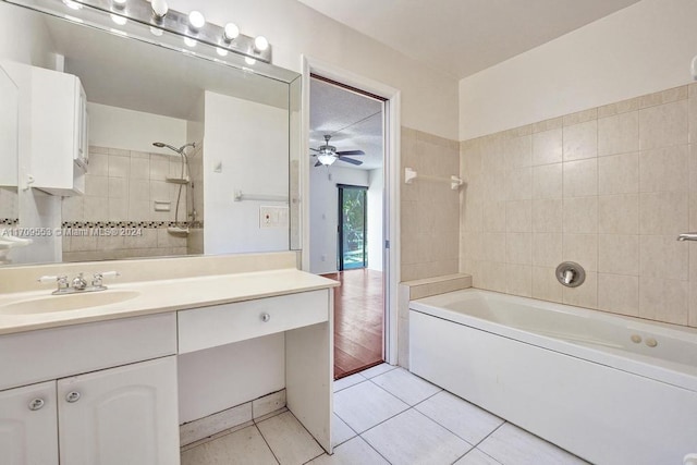 bathroom with ceiling fan, vanity, wood-type flooring, and tiled shower / bath combo