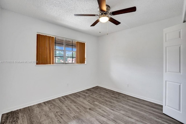 unfurnished room featuring wood-type flooring, a textured ceiling, and ceiling fan