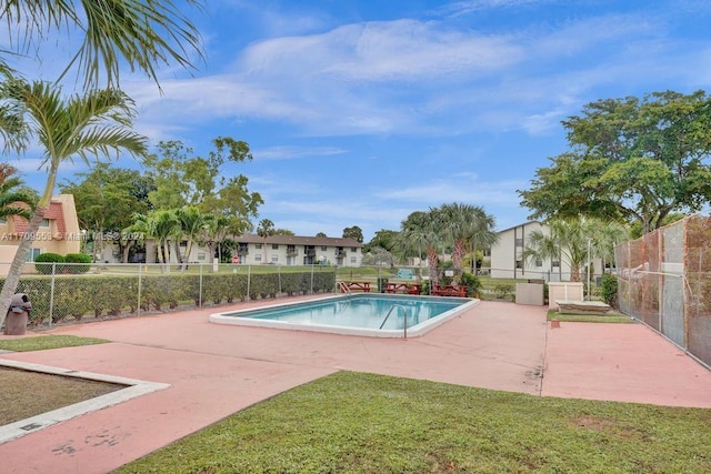 view of swimming pool featuring a yard and a patio area