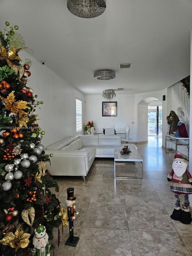 unfurnished living room with a notable chandelier