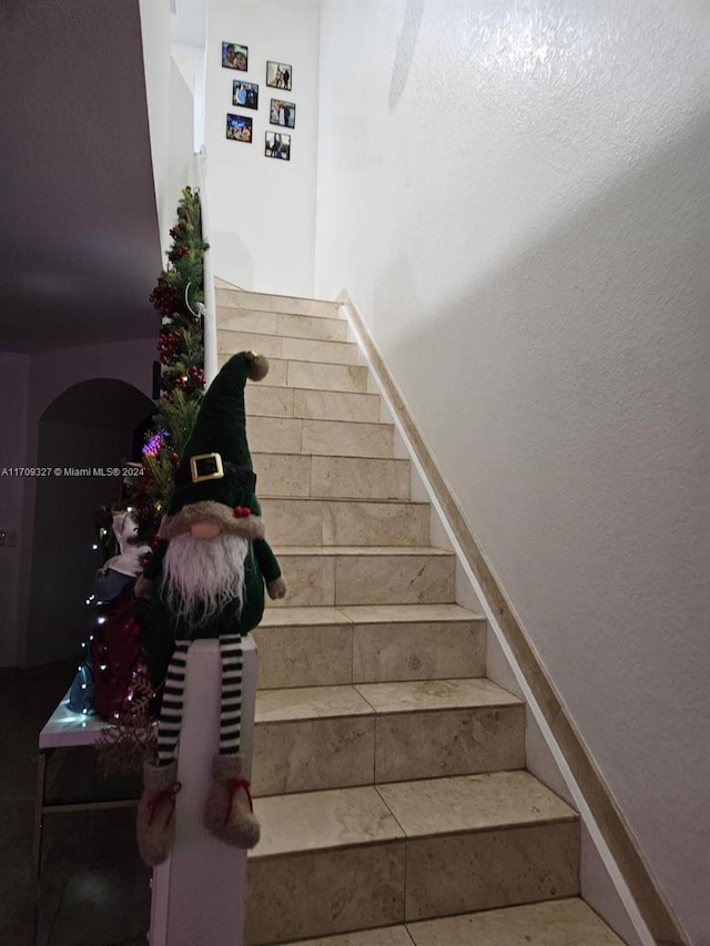 stairway with tile patterned flooring