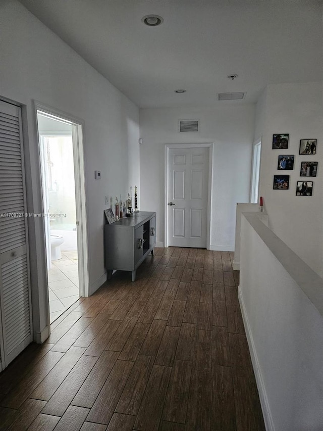 hall with dark hardwood / wood-style flooring