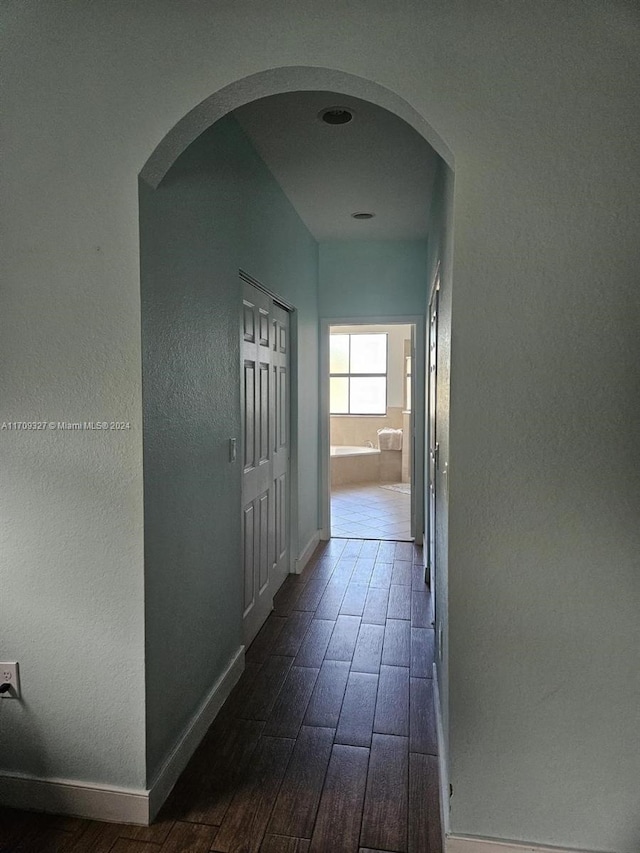 corridor with dark hardwood / wood-style floors