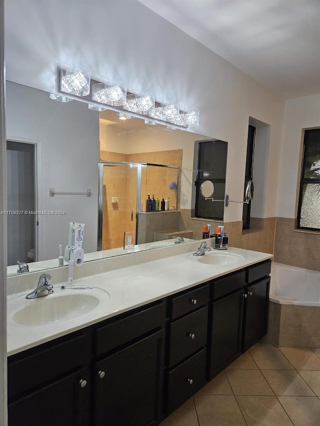 bathroom with tile patterned floors, vanity, and shower with separate bathtub