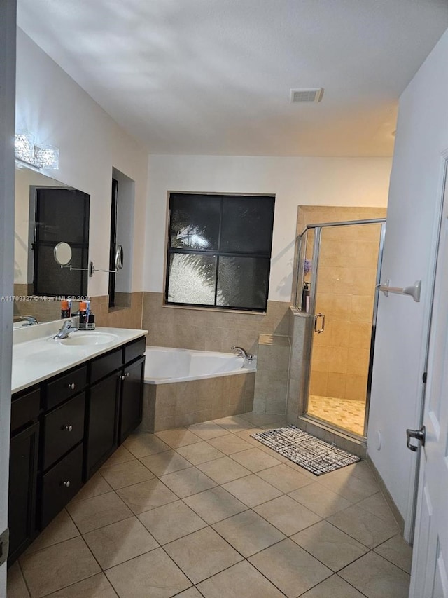 bathroom with tile patterned floors, vanity, and independent shower and bath