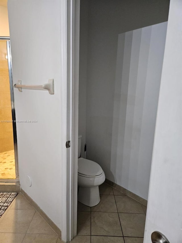 bathroom with tile patterned floors and toilet