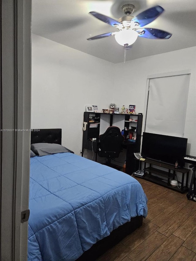 bedroom with ceiling fan and dark wood-type flooring