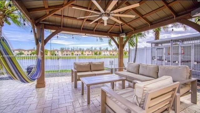 view of patio / terrace with a gazebo, ceiling fan, a water view, and an outdoor hangout area