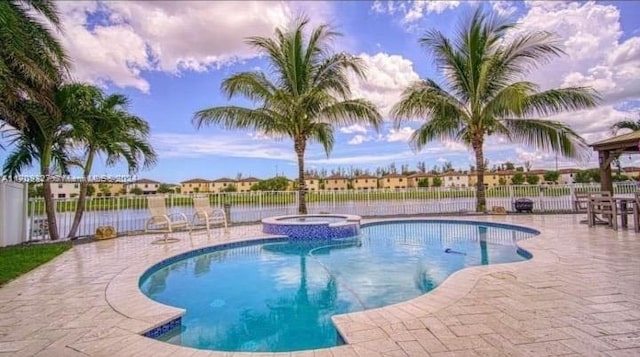 view of pool with an in ground hot tub and a patio