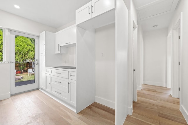 kitchen featuring white cabinets, light wood-type flooring, and plenty of natural light