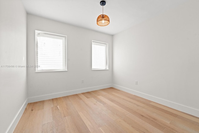 empty room with light hardwood / wood-style flooring