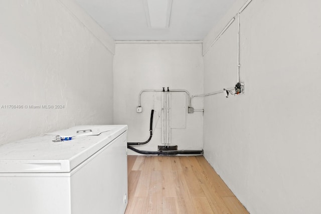 laundry room featuring washer / clothes dryer and light hardwood / wood-style flooring