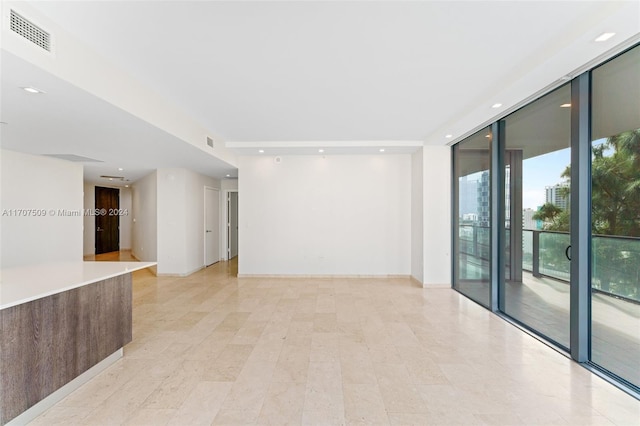 spare room featuring expansive windows