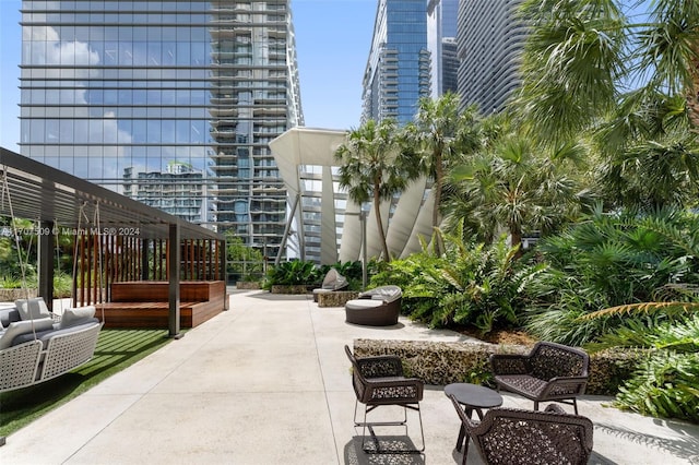 view of home's community with outdoor lounge area, a pergola, and a patio