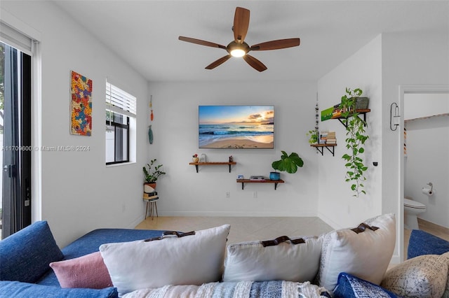 tiled living room with ceiling fan