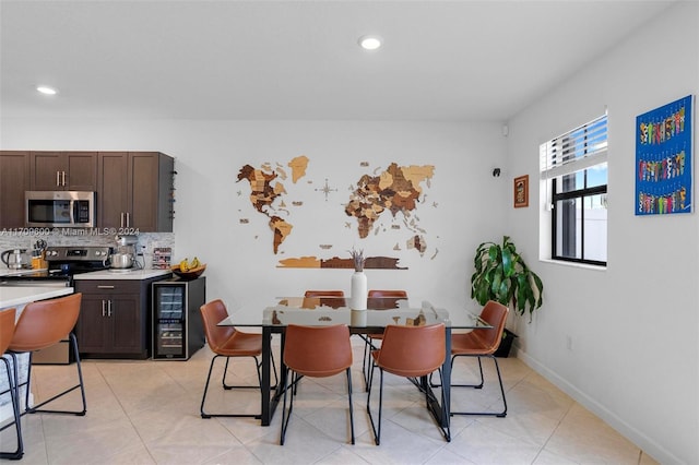 dining area with light tile patterned floors and beverage cooler