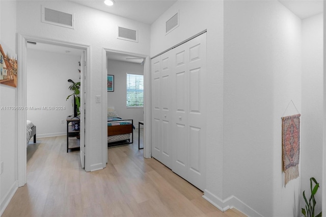 hallway with light hardwood / wood-style flooring