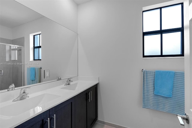 bathroom with plenty of natural light, vanity, and a shower with door