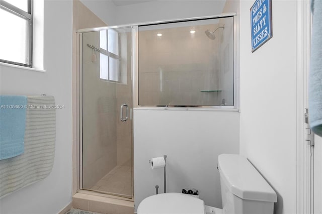 bathroom featuring toilet and walk in shower