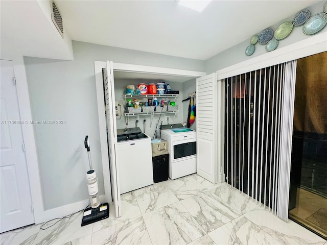 laundry area with washing machine and clothes dryer