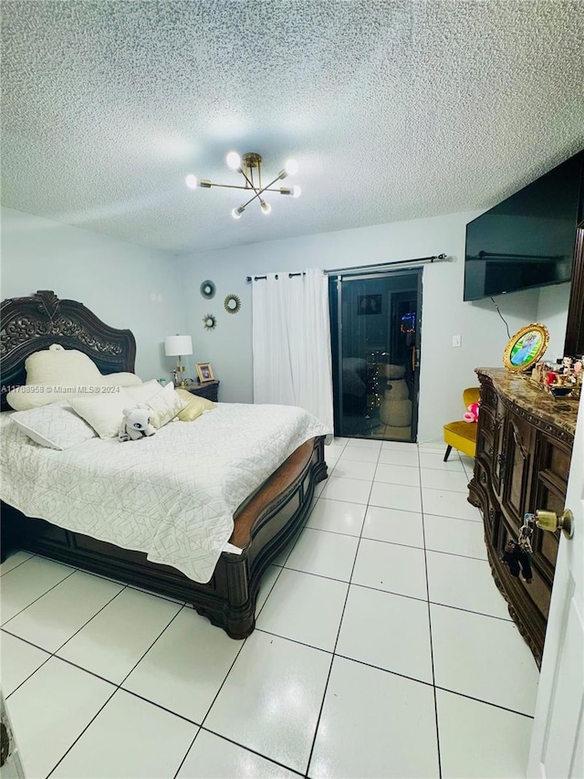 bedroom with tile patterned floors, a chandelier, and a textured ceiling