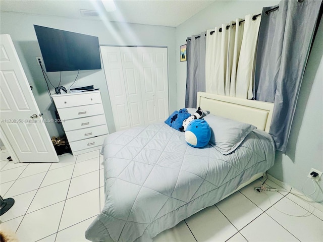 bedroom featuring tile patterned flooring and a closet