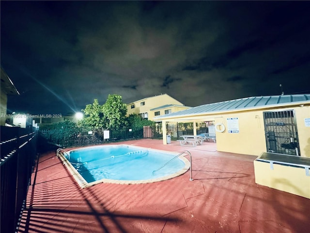 pool at night with a patio