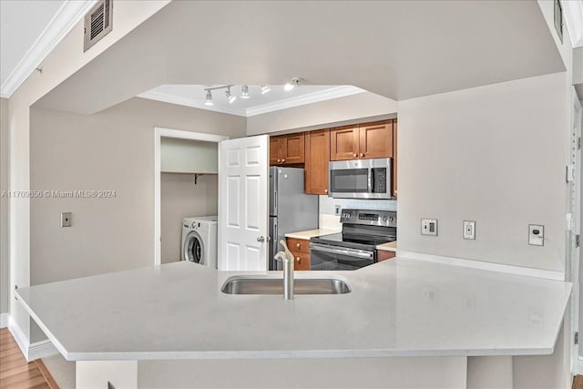 kitchen with sink, light hardwood / wood-style flooring, kitchen peninsula, appliances with stainless steel finishes, and ornamental molding