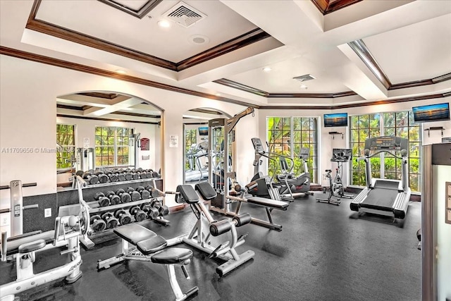 exercise room with ornamental molding, coffered ceiling, and a raised ceiling