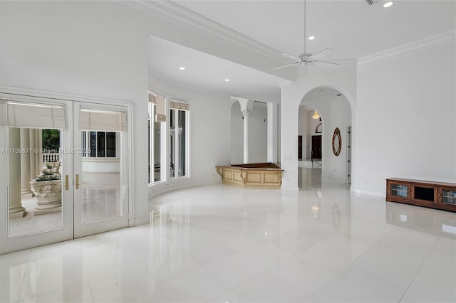 interior space with ceiling fan and ornamental molding