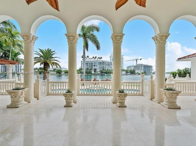 view of patio featuring ceiling fan and a water view