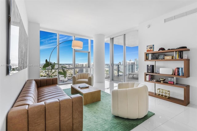 living room with floor to ceiling windows and light tile patterned floors