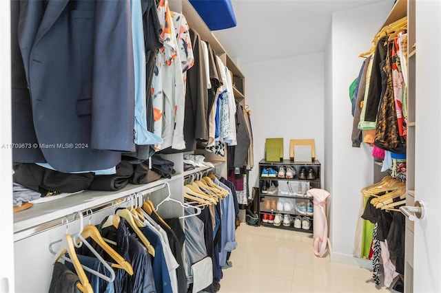 walk in closet with light tile patterned floors